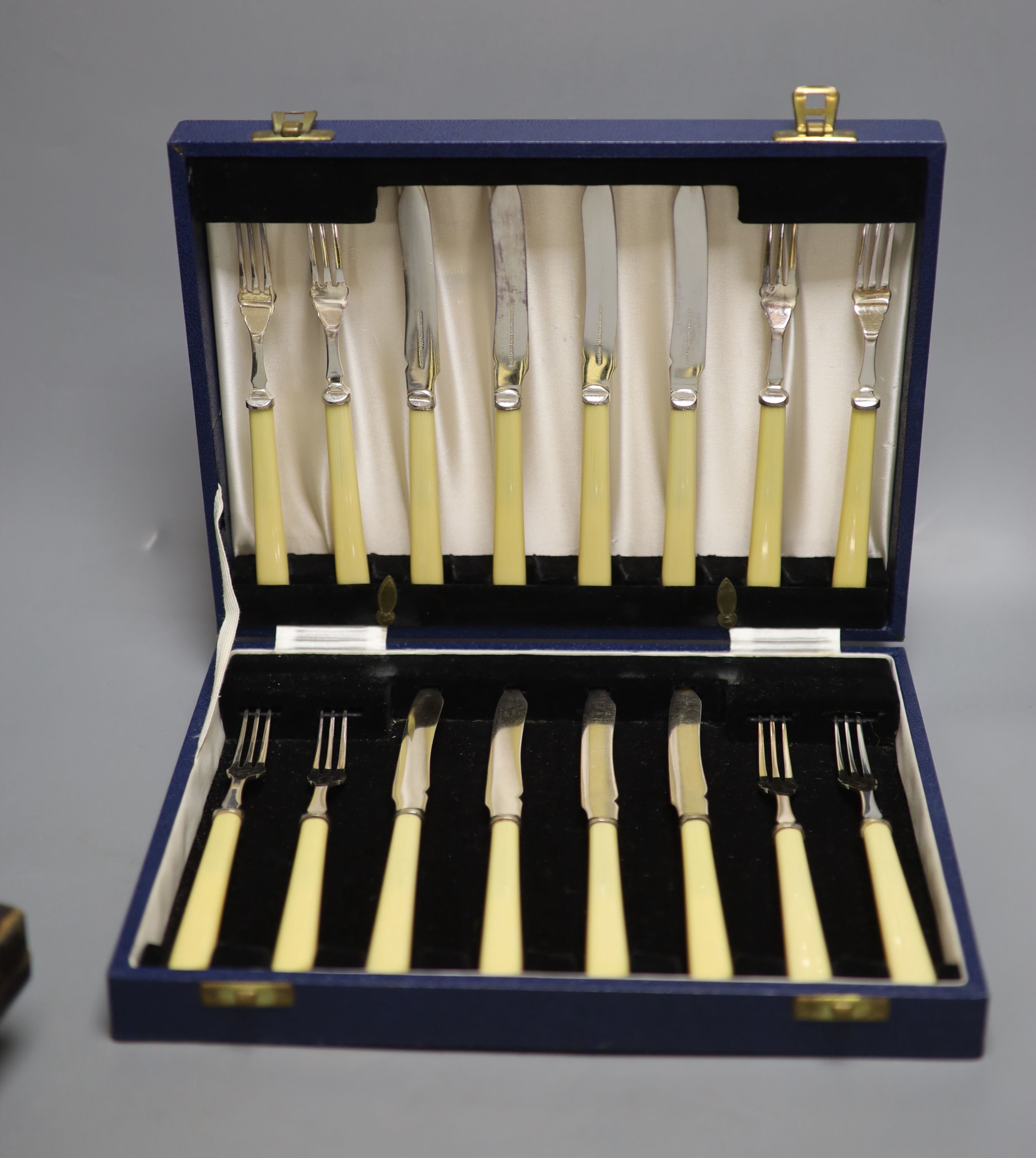 A silver-mounted amber cheroot holder, cased, with Russian inscription, Birmingham 1896 and sundry silver and plated flatware,